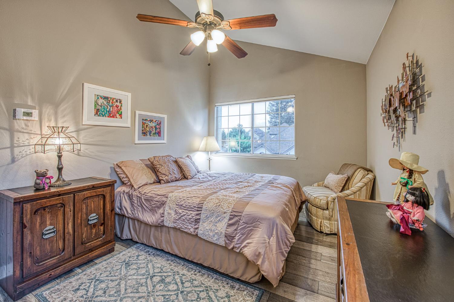 3077 West Pembrook Loop Fresno, CA 93711 - Photo 51 of 56 a bedroom with a bed and a chandelier