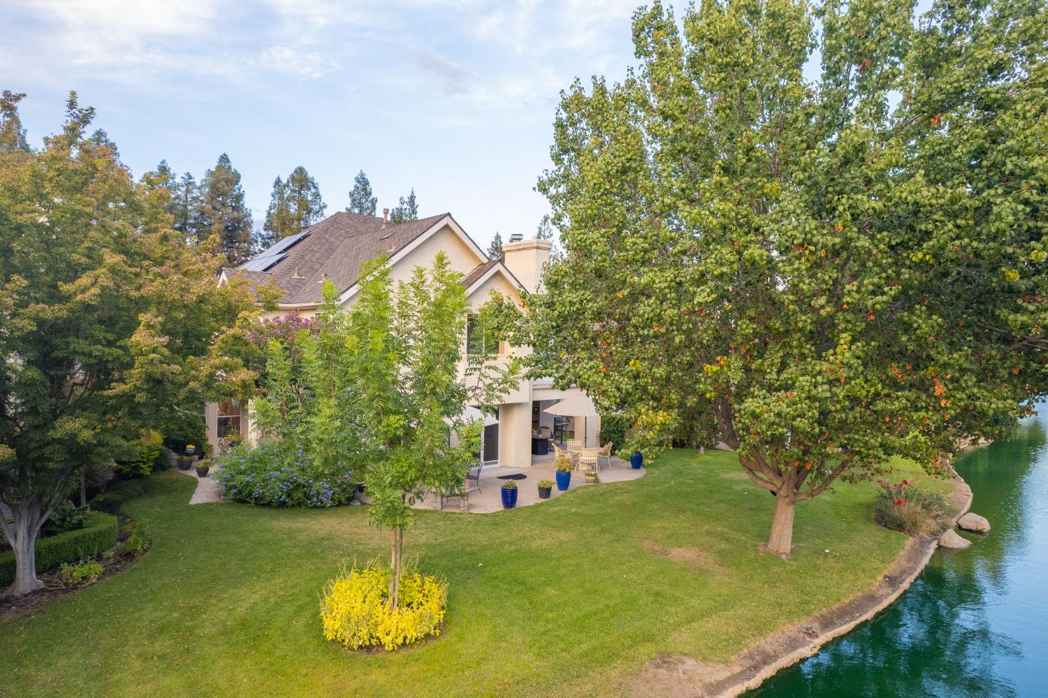 3077 West Pembrook Loop Fresno, CA 93711 - Photo 9 of 56 a view of a house with a yard and plants