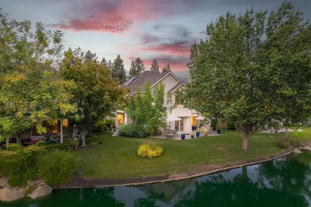 a view of a house with swimming pool and tennis court