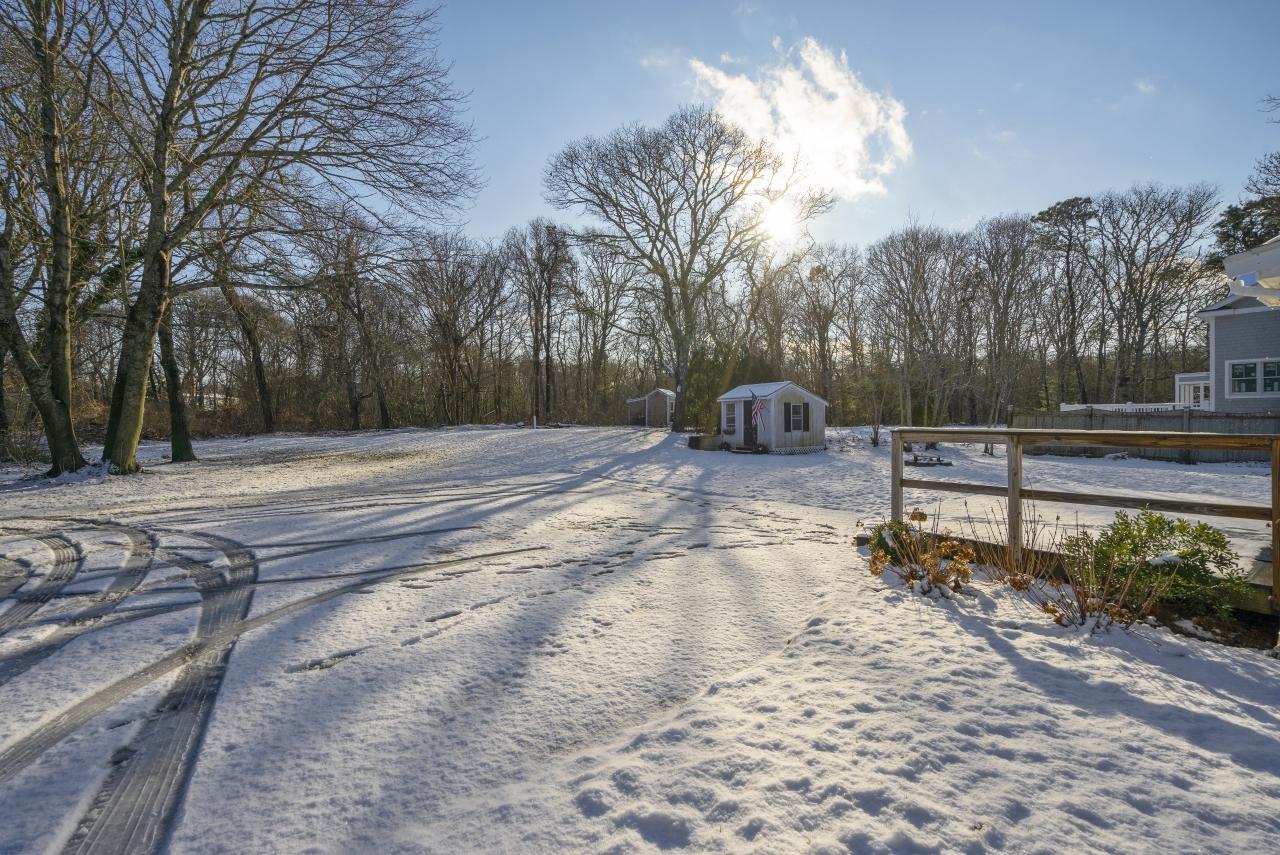 59 Fire Station Road Osterville, MA 02655 - Photo 23 of 31 a backyard of a house with trees and outdoor space