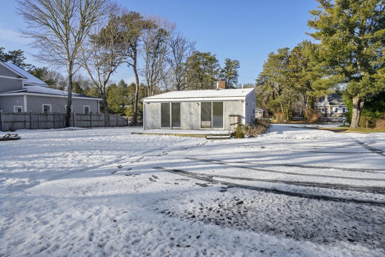 59 Fire Station Road Osterville, MA 02655 - Photo 24 of 31 a front view of house with yard and trees in the background