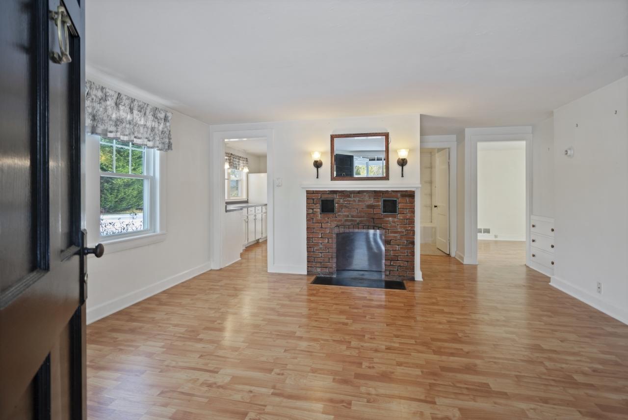 59 Fire Station Road Osterville, MA 02655 - Photo 3 of 31 a view of empty room with fireplace and wooden floor