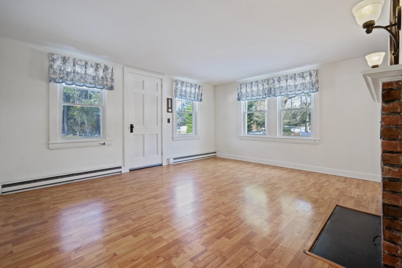 59 Fire Station Road Osterville, MA 02655 - Photo 4 of 31 a view of an empty room with wooden floor and a window