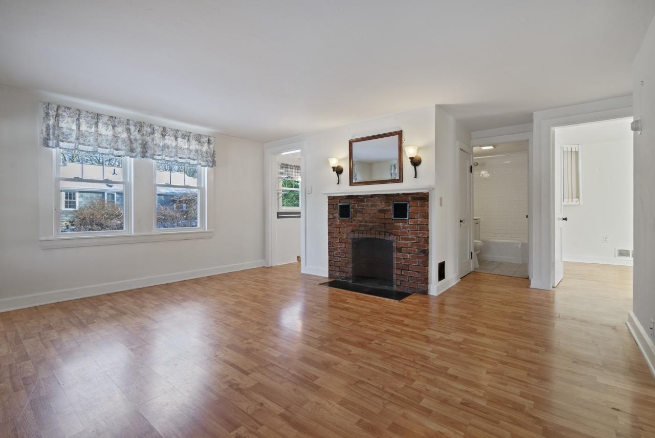59 Fire Station Road Osterville, MA 02655 - Photo 5 of 31 an empty room with windows and a fireplace