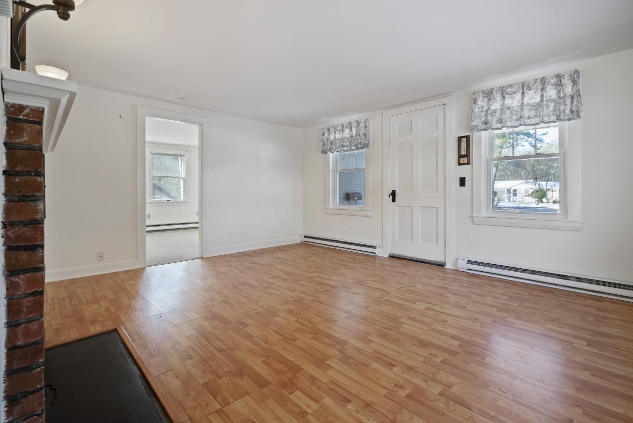 59 Fire Station Road Osterville, MA 02655 - Photo 8 of 31 an empty room with wooden floor and windows