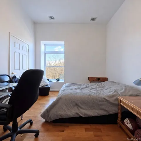 a bedroom that has a bed and a chair in it