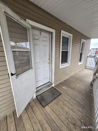 a view of outdoor space with wooden floor and windows