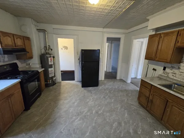 a kitchen with stainless steel appliances granite countertop a refrigerator stove and sink