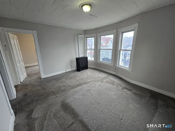 an empty room with windows and entrance