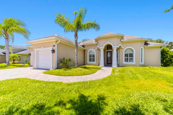 a front view of a house with yard and garage