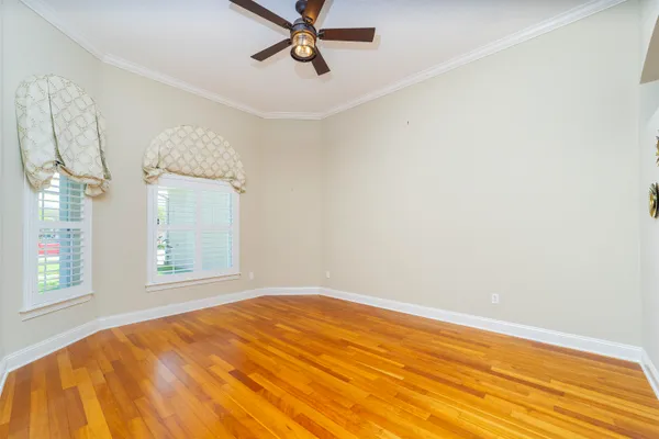 a view of a living room with kitchen island furniture and a ceiling fan