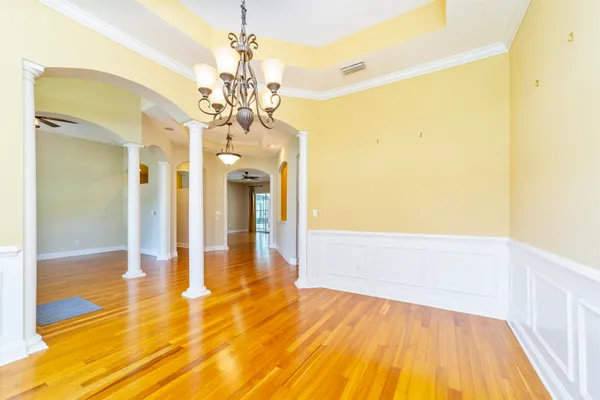 a kitchen with stainless steel appliances granite countertop a stove a sink and a microwave oven with white cabinets