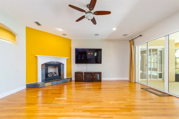 a large kitchen with stainless steel appliances granite countertop a stove and a wooden floors