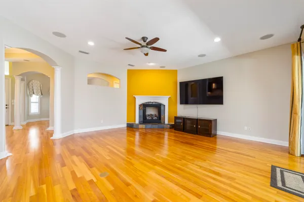 a view of a hallway with wooden floor and staircase