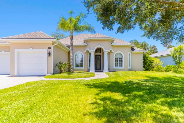 a front view of a house with a yard and garage