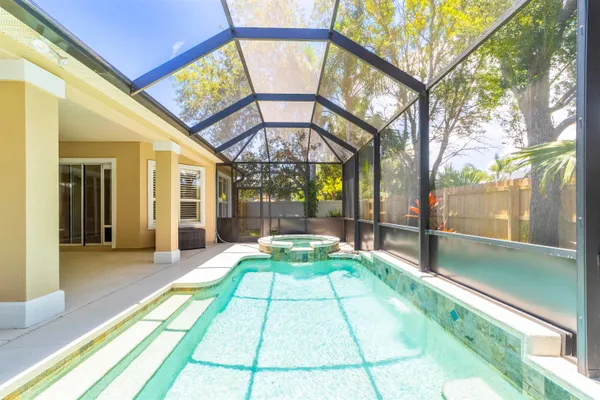 a spacious bathroom with a tub sink and mirror