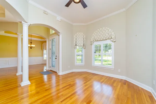 a view of a kitchen with a fireplace a sink and dishwasher with wooden floor