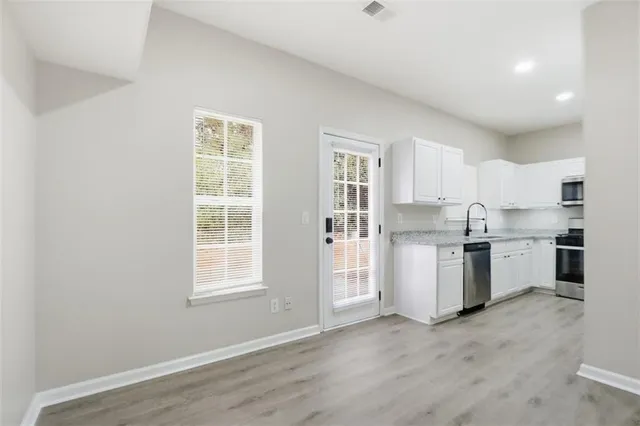 a white bath tub sitting next to a white wall