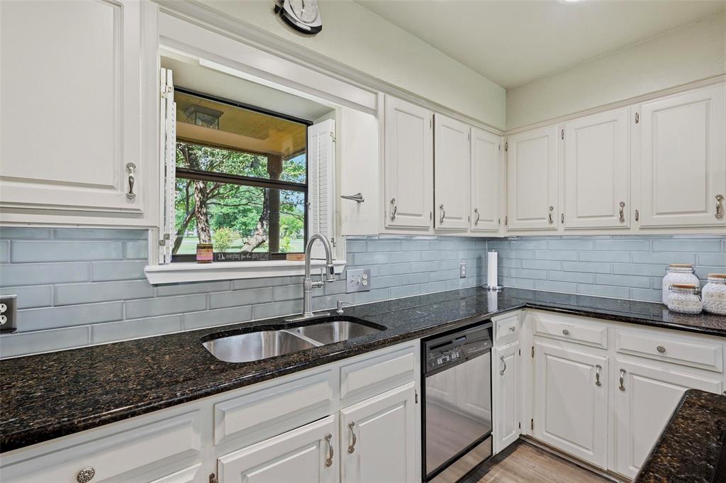 522 High Country Road Sherman, TX 75092 - Photo 12 of 38 a kitchen with stainless steel appliances white cabinets and a sink