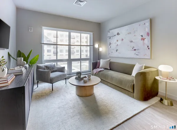 a living room with furniture and a large window