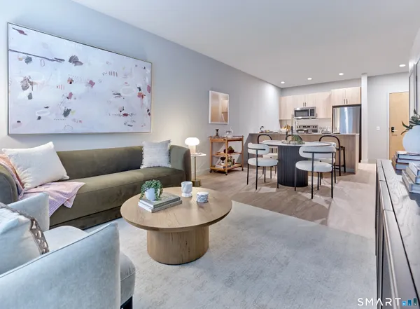 a living room with furniture and kitchen view