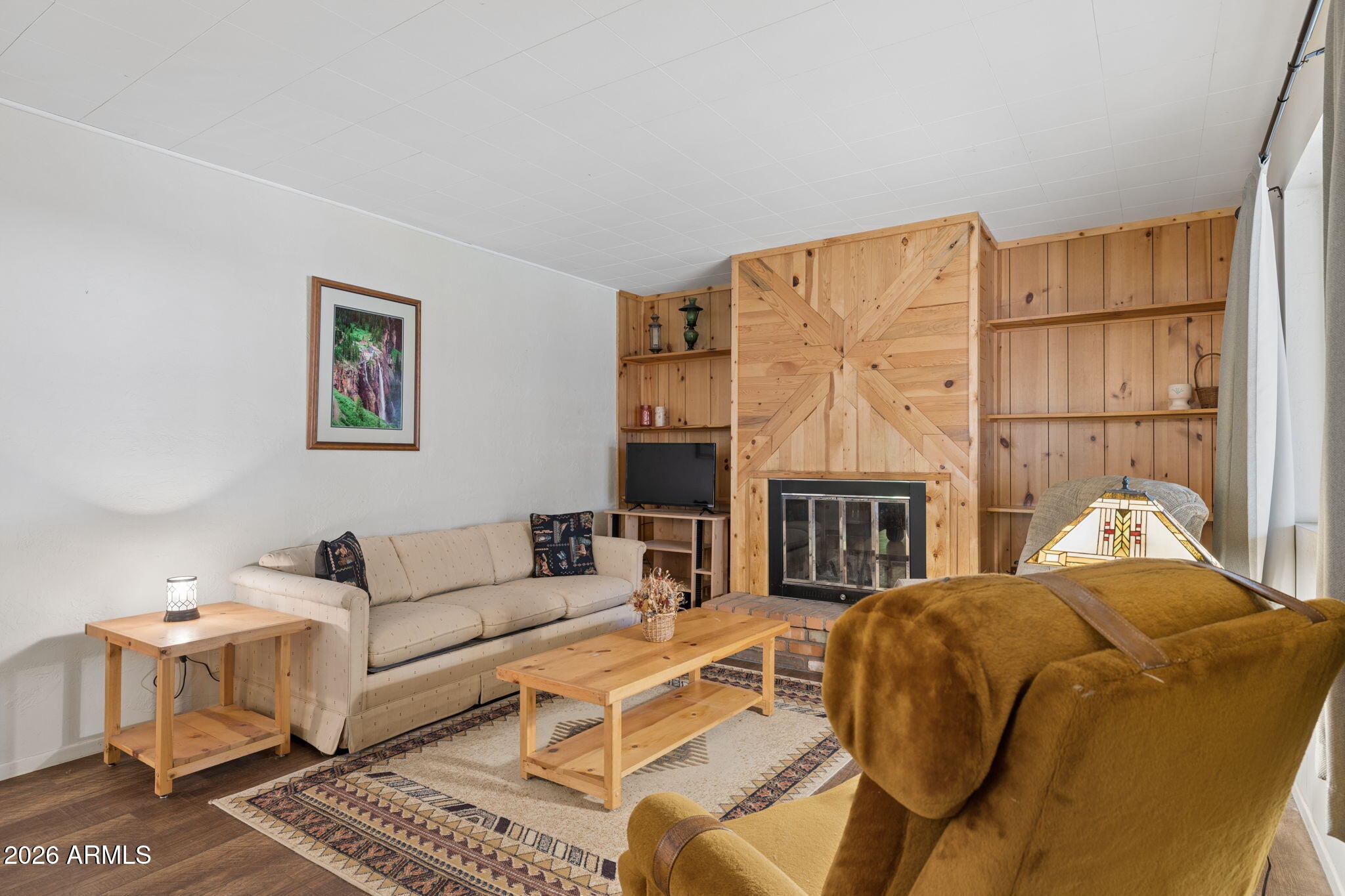 8726 Emmas View Pine, AZ 85544 - Photo 6 of 29 a living room with furniture a fireplace and a table