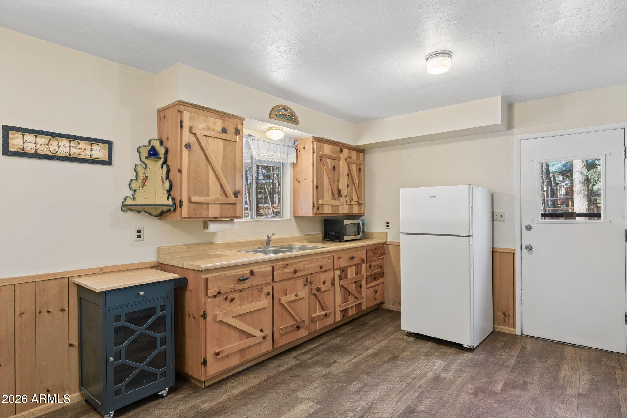 8726 Emmas View Pine, AZ 85544 - Photo 10 of 29 a kitchen with a refrigerator a sink and wooden floor