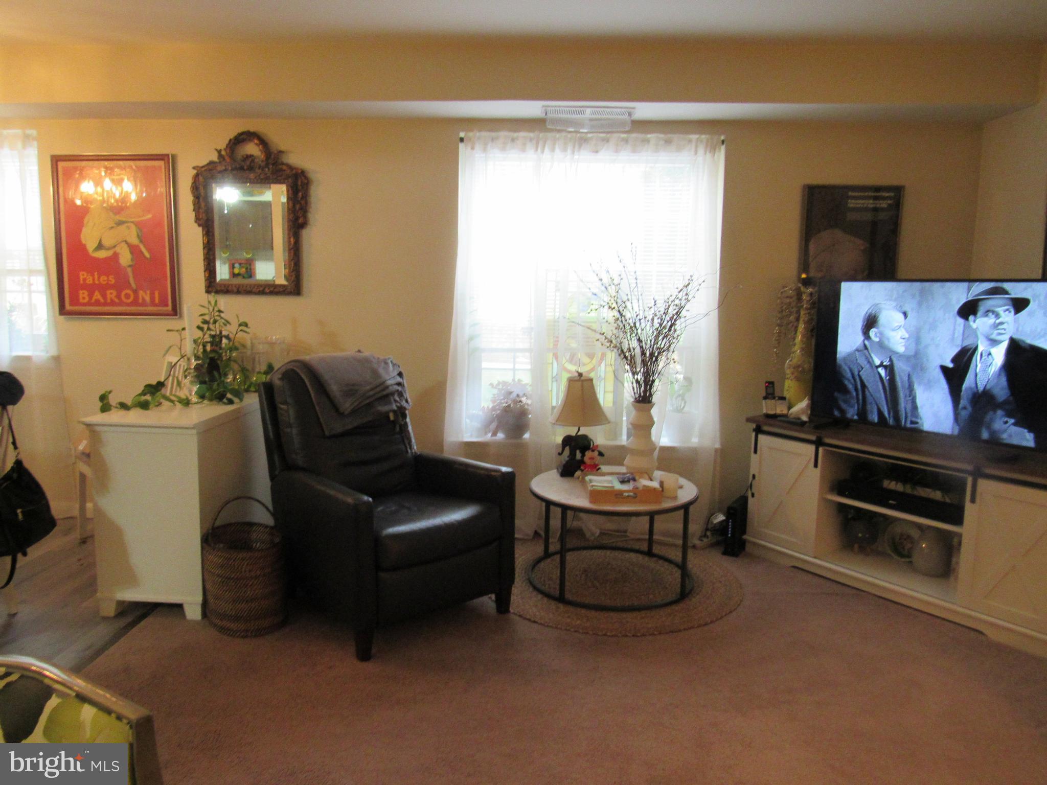 4000 Gypsy Lane, Unit 622F1 Philadelphia, PA 19129 - Photo 15 of 45 a living room with furniture and a flat screen tv