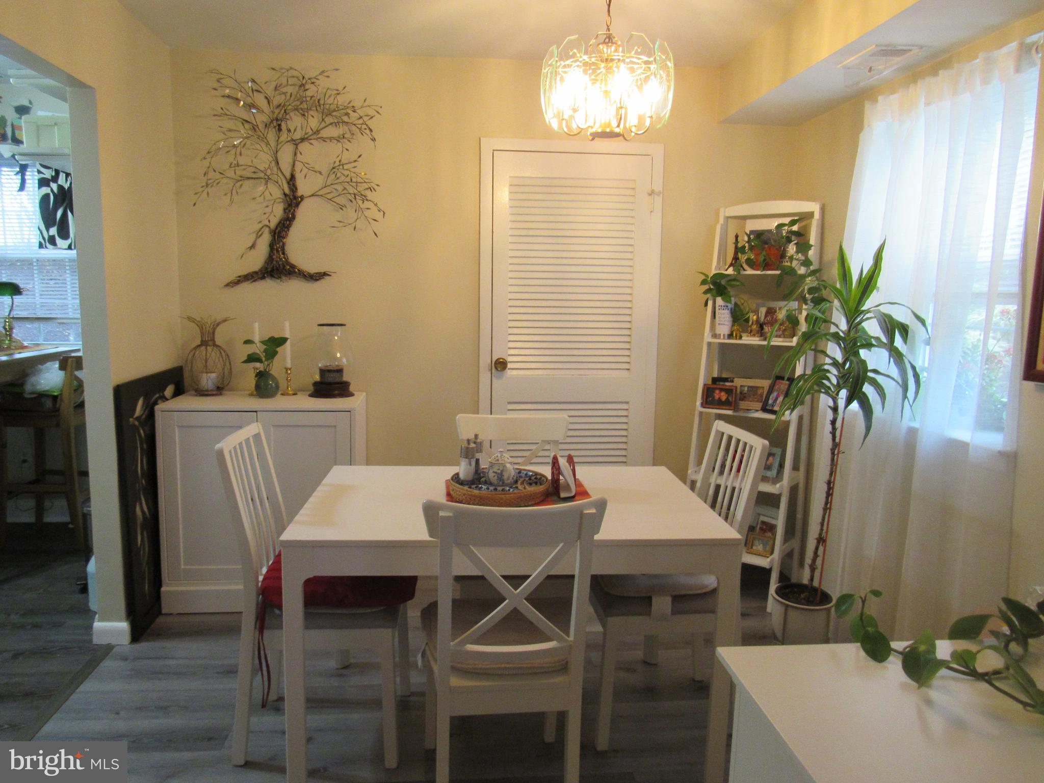 4000 Gypsy Lane, Unit 622F1 Philadelphia, PA 19129 - Photo 16 of 45 a view of a dining room with furniture and chandelier
