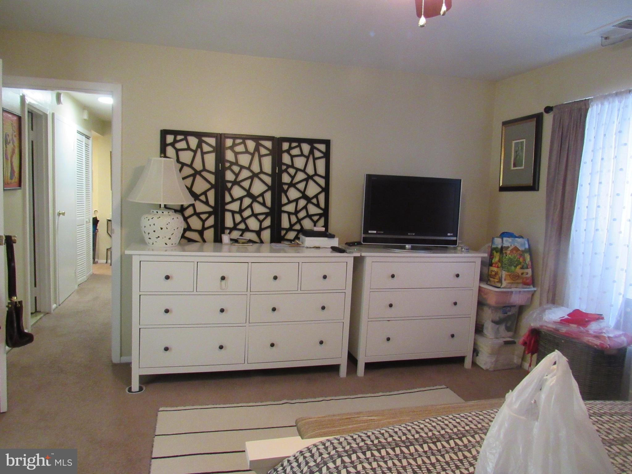 4000 Gypsy Lane, Unit 622F1 Philadelphia, PA 19129 - Photo 28 of 45 a room with a dresser and a flat screen tv