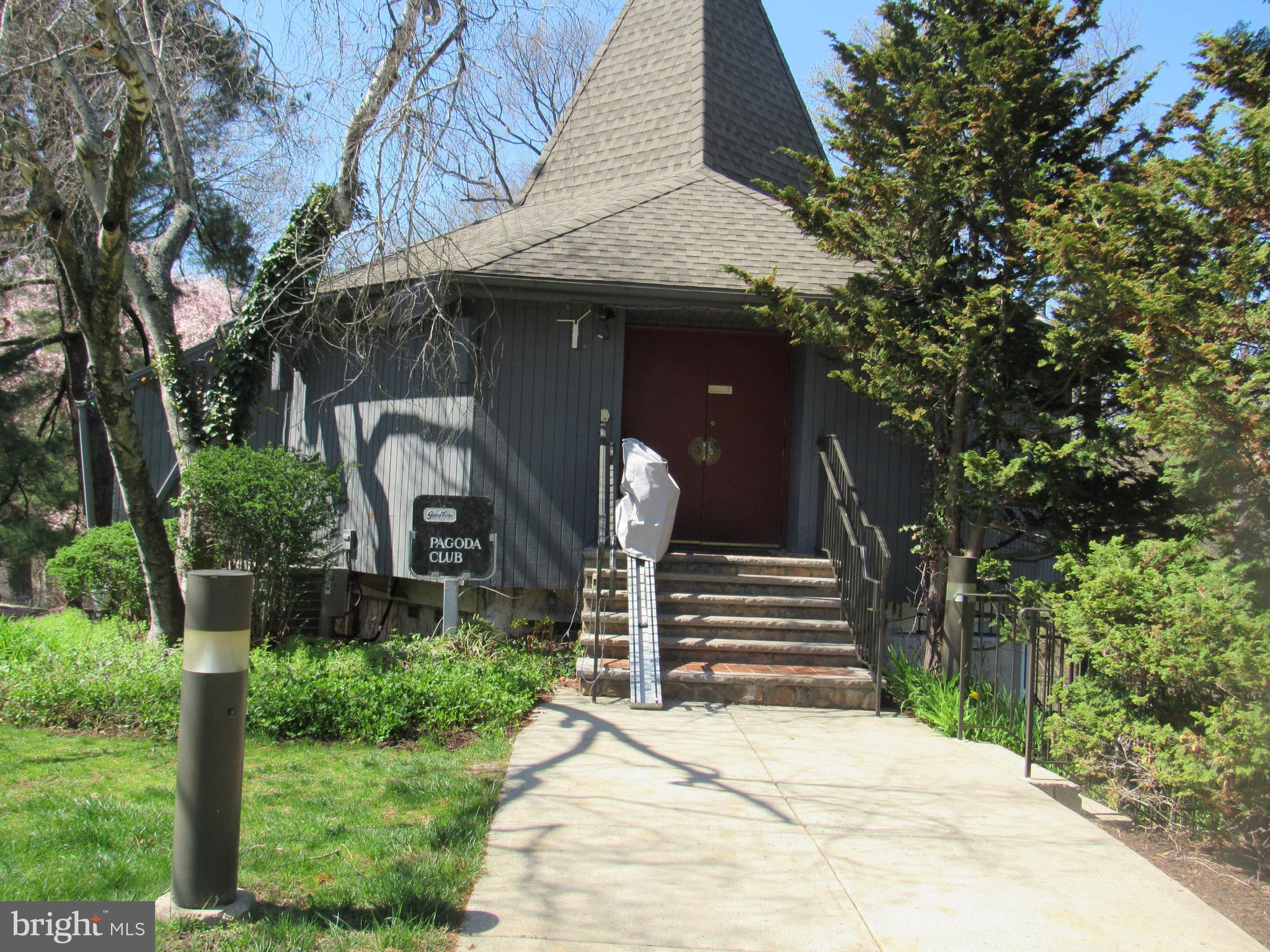 4000 Gypsy Lane, Unit 622F1 Philadelphia, PA 19129 - Photo 34 of 45 a front view of a house with a garden