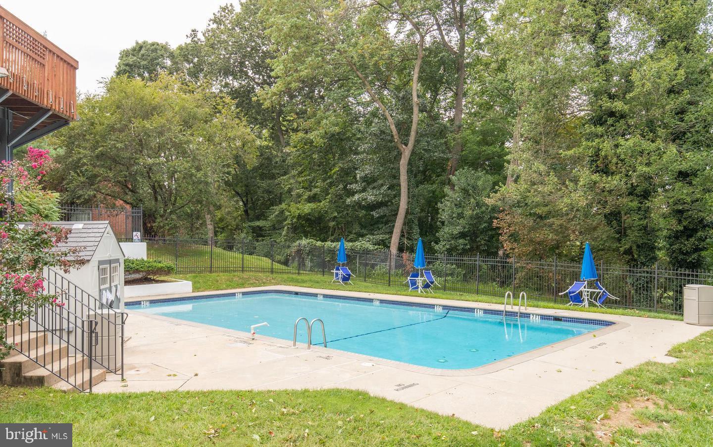4000 Gypsy Lane, Unit 622F1 Philadelphia, PA 19129 - Photo 39 of 45 a view of a swimming pool with a yard and sitting area