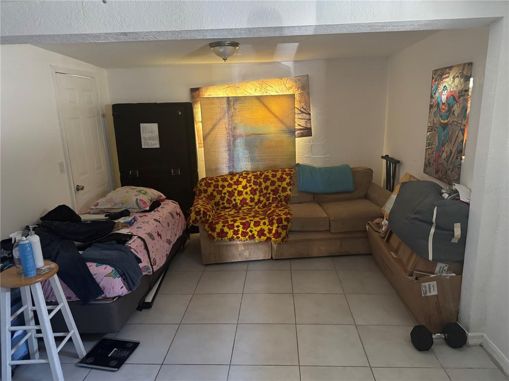 1620 36th Street Orlando, FL 32839 - Photo 4 of 7 a living room with furniture and a flat screen tv