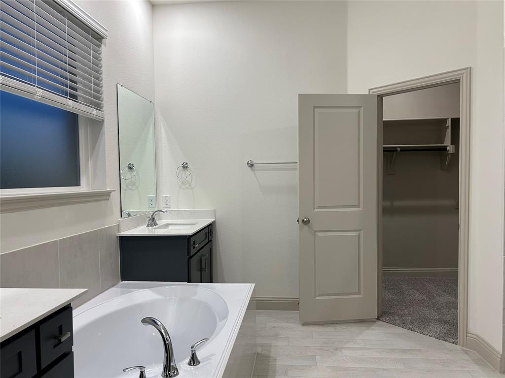 2905 Italia Terrace Princeton, TX 75407 - Photo 15 of 22 a bathroom with a sink and mirror