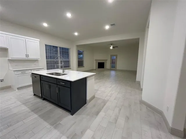 a kitchen with a sink and a stove top oven