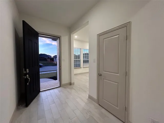 a view of an empty room and kitchen view