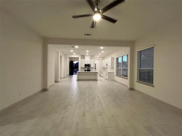 a kitchen with kitchen island a sink appliances and cabinets
