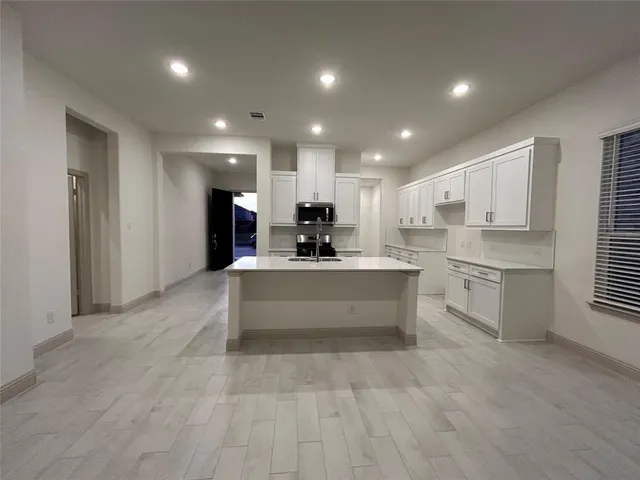 a kitchen with a sink and a refrigerator