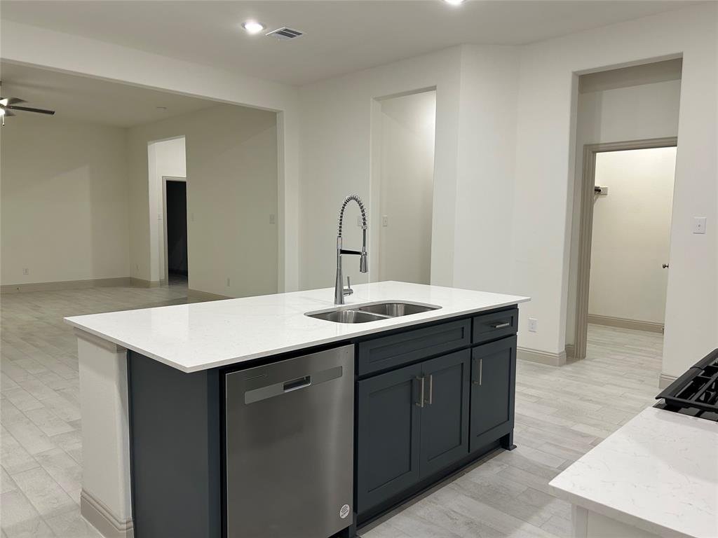2905 Italia Terrace Princeton, TX 75407 - Photo 8 of 22 a kitchen with a sink and a refrigerator