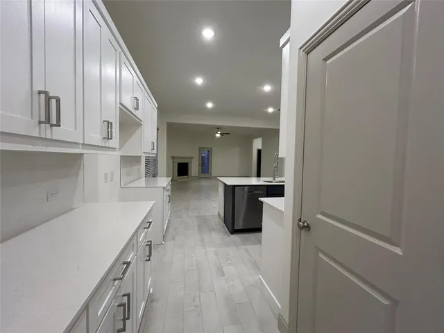 a kitchen with a sink appliances and cabinets