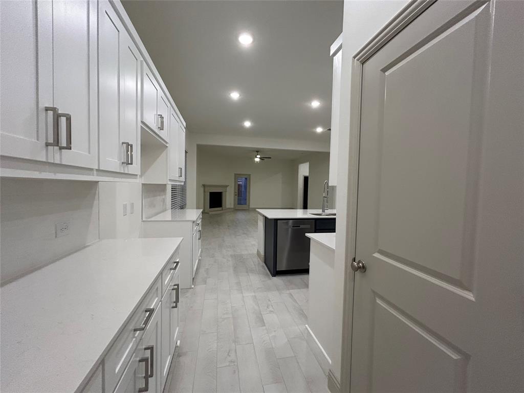 2905 Italia Terrace Princeton, TX 75407 - Photo 9 of 22 a open kitchen with white cabinets and stainless steel appliances