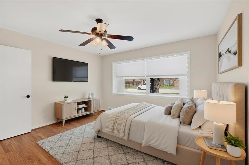 2120 Healey Drive Dallas, TX 75228 - Photo 21 of 39 a bedroom with a bed and a flat screen tv