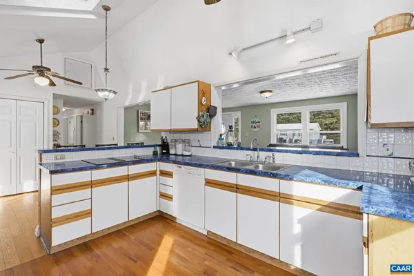 a large kitchen with stainless steel appliances granite countertop a sink and cabinets