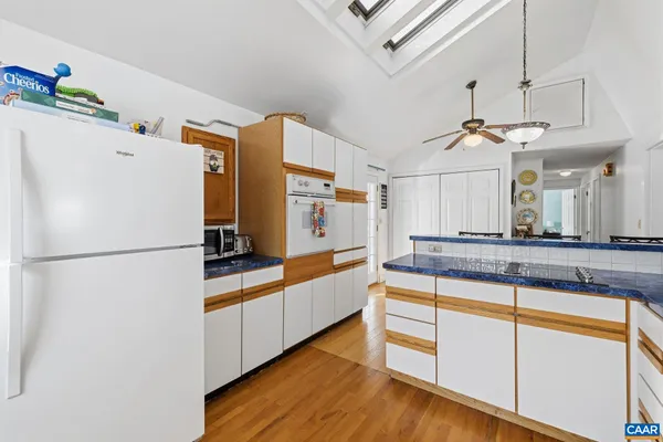 a kitchen with stainless steel appliances a refrigerator and a stove