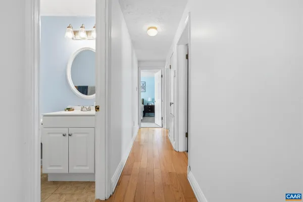 a view of a hallway with wooden floor