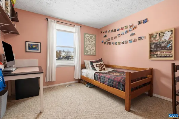 a bedroom with a bed and a desk