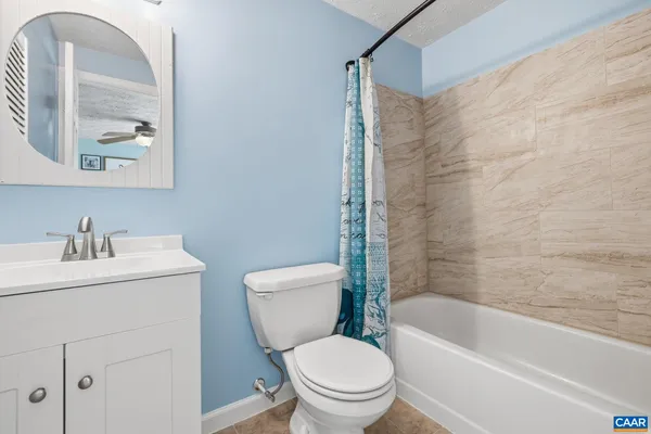 a white toilet sitting next to a bath tub