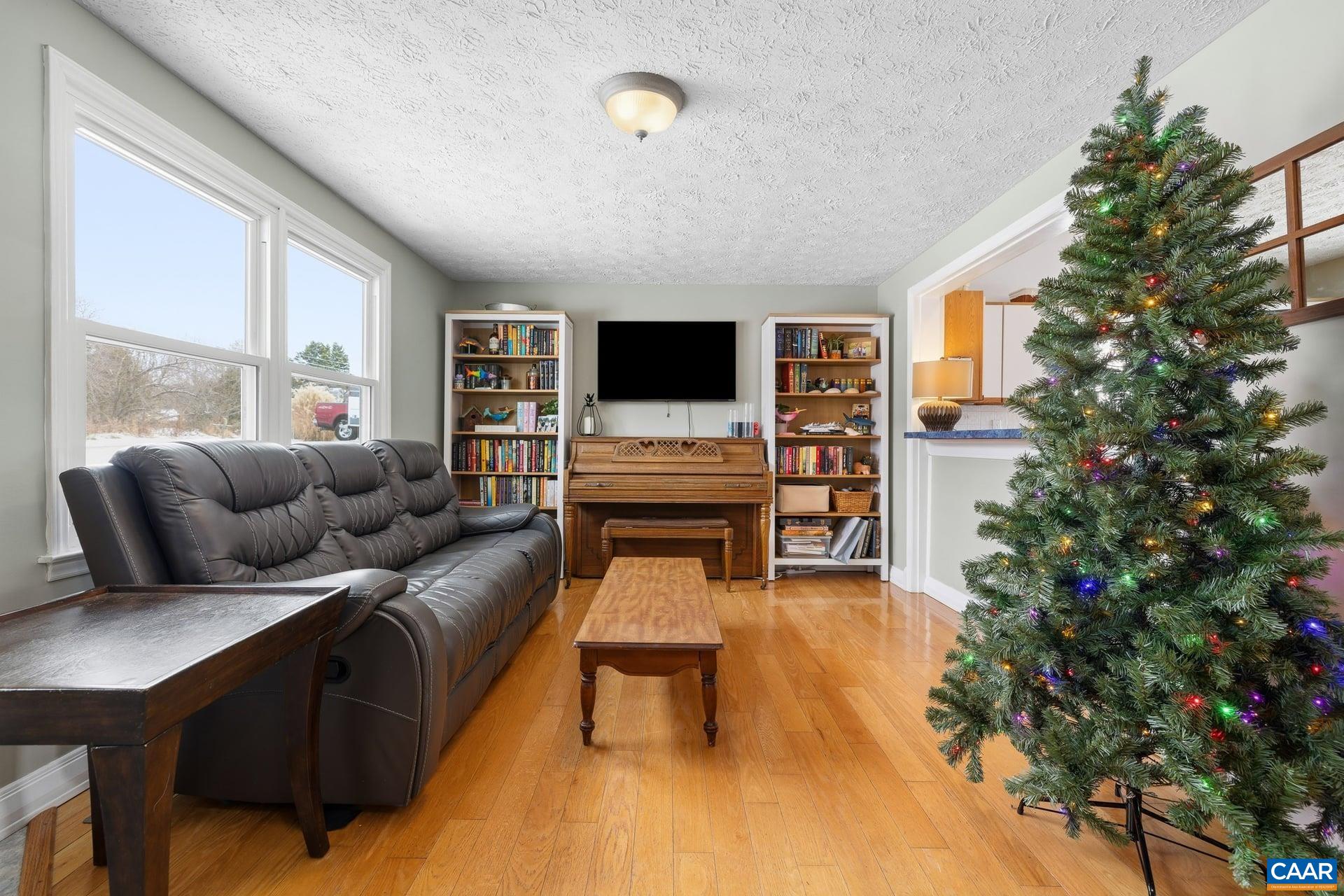 979 Cedar Grove Road Ruckersville, VA 22968 - Photo 6 of 33 a living room with furniture and a flat screen tv