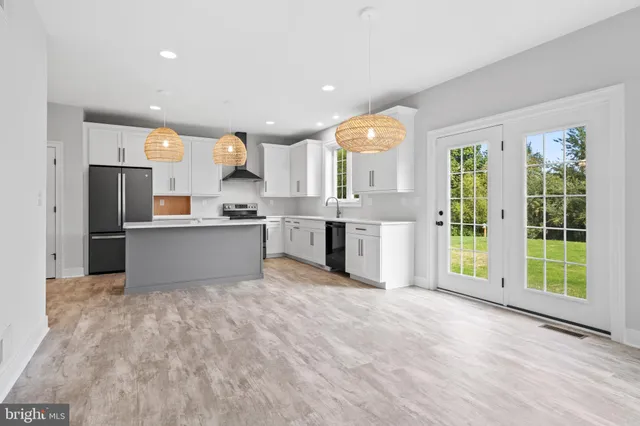 a kitchen with stainless steel appliances granite countertop a stove and a sink