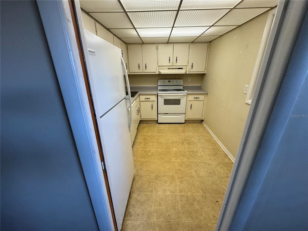 245 Center Road, Unit 211 Venice, FL 34285 - Photo 3 of 9 a view of a kitchen with wooden floor and electronic appliances